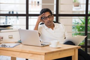 Guy stressed sitting at the table - Different types of stress